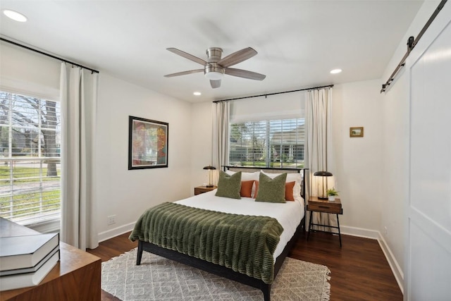 1213 S Church St, Georgetown, TX 78626 - bedroom with a barn door, recessed lighting, wood finished floors, baseboards, and ceiling fan