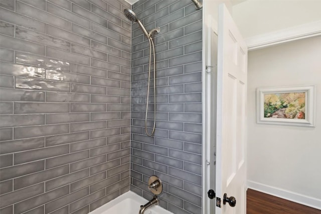 1213 S Church St, Georgetown, TX 78626 - bathroom featuring shower / tub combination, baseboards, and wood finished floors