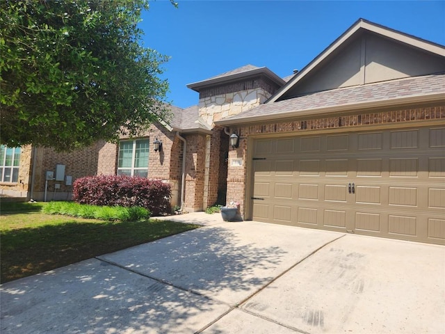 view of front of home with concrete driveway, a garage, stone siding, and brick siding