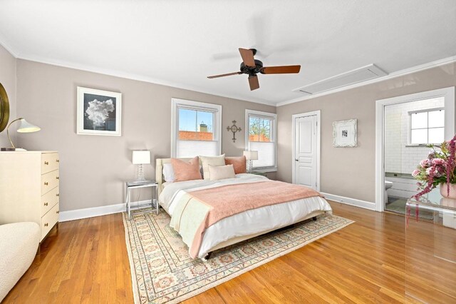 bedroom featuring attic access, baseboards, crown molding, and light wood-type flooring