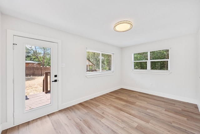 125 Chaparral St, San Marcos, TX 78666 - doorway featuring plenty of natural light, light wood-type flooring, and baseboards
