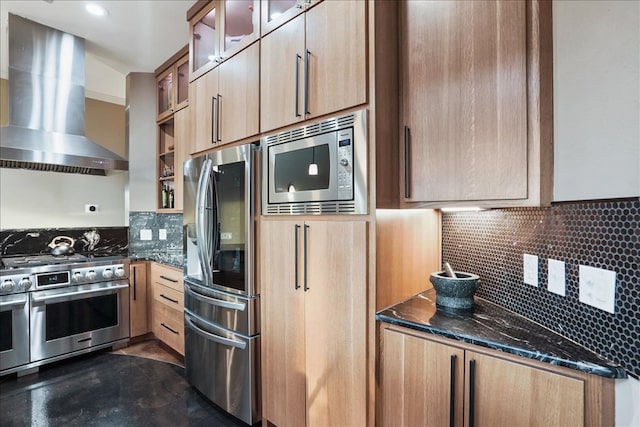 1002 Arroweye Trl, Austin, TX 78733 - kitchen with stainless steel appliances, wall chimney exhaust hood, backsplash, glass insert cabinets, and concrete floors