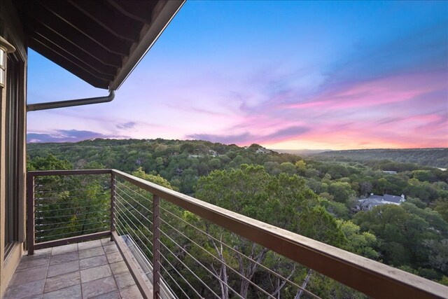 1002 Arroweye Trl, Austin, TX 78733 - balcony at dusk with a view of trees