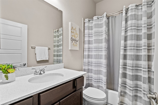 full bathroom featuring toilet, shower / bath combination with curtain, and vanity