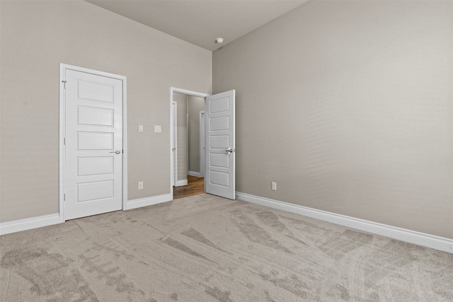 unfurnished bedroom with baseboards and carpet flooring