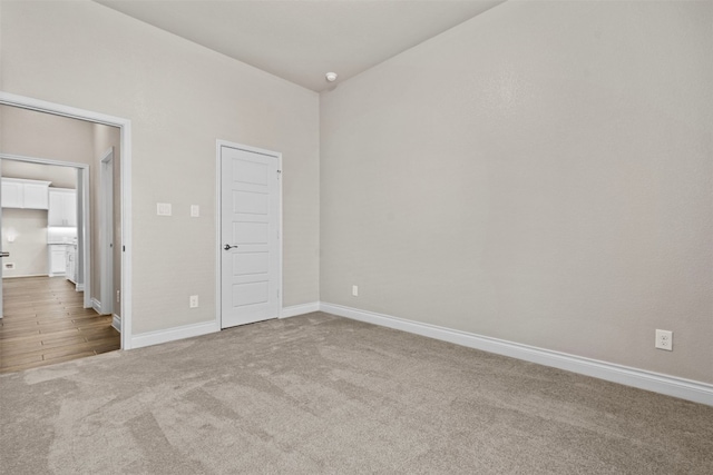 unfurnished bedroom with baseboards and carpet flooring