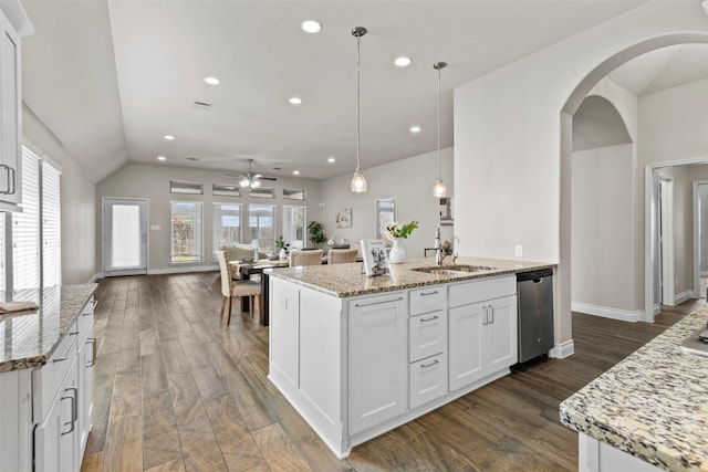 kitchen with a ceiling fan, arched walkways, white cabinetry, a sink, and stainless steel dishwasher