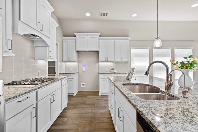 kitchen with dark wood-type flooring, white cabinetry, a sink, and stainless steel appliances