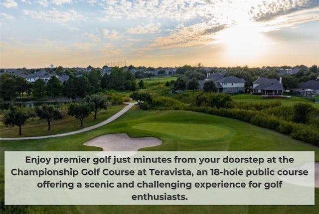 surrounding community with golf course view and a yard