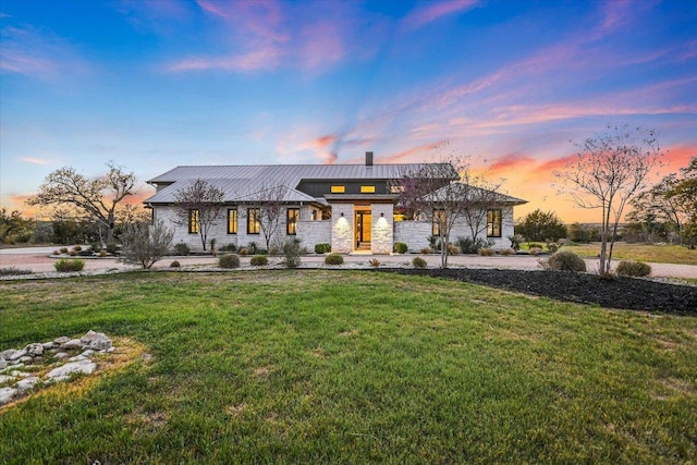 343 Pug Rippy, Dripping Springs, TX 78620 - view of front facade featuring stone siding, a front lawn, a standing seam roof, and metal roof