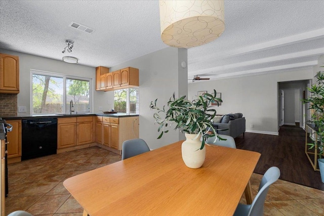 dining space featuring a ceiling fan, a textured ceiling, and visible vents