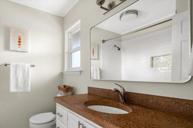 full bathroom featuring vanity, walk in shower, and toilet
