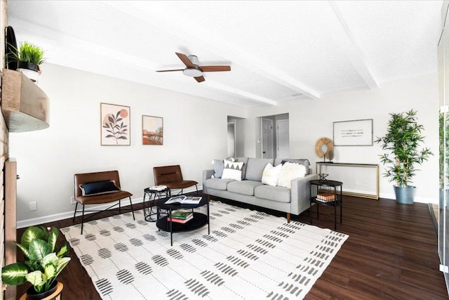 living room featuring baseboards, ceiling fan, wood finished floors, and beam ceiling