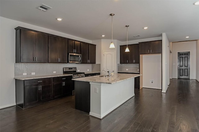 908 Leadtree Loop, Buda, TX 78610 - kitchen with stainless steel appliances, light stone countertops, dark brown cabinetry, backsplash, and a sink