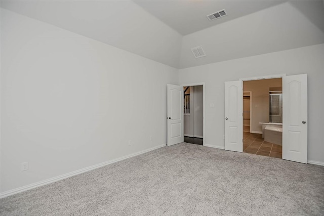 908 Leadtree Loop, Buda, TX 78610 - unfurnished bedroom with carpet floors, baseboards, a spacious closet, and high vaulted ceiling