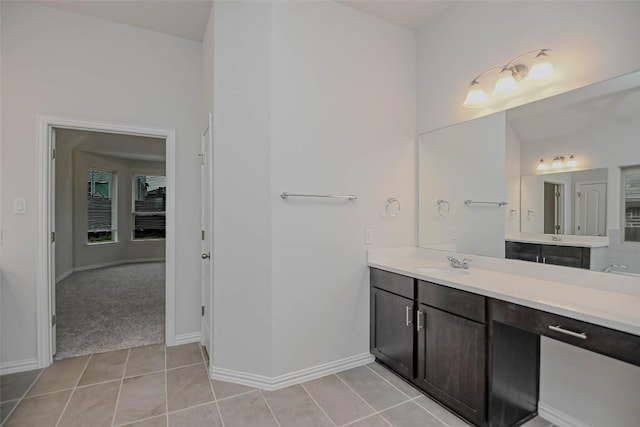 908 Leadtree Loop, Buda, TX 78610 - bathroom with vanity, tile patterned flooring, and baseboards