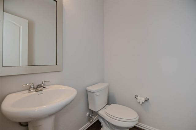 908 Leadtree Loop, Buda, TX 78610 - half bathroom with baseboards, toilet, and a sink