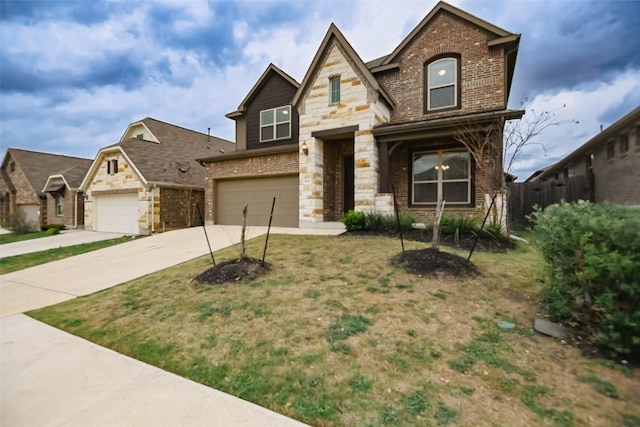 908 Leadtree Loop, Buda, TX 78610 - view of front facade featuring brick siding, stone siding, an attached garage, and concrete driveway