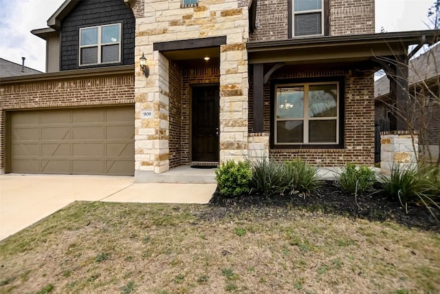 908 Leadtree Loop, Buda, TX 78610 - view of front of property featuring brick siding, a garage, concrete driveway, and stone siding