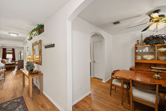 3919 Haleys Way, Round Rock, TX 78665 - dining area featuring arched walkways, ceiling fan, wood finished floors, and baseboards