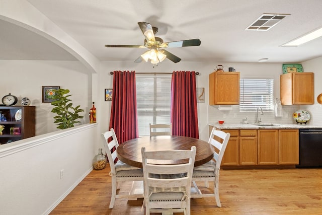 3919 Haleys Way, Round Rock, TX 78665 - dining space with light wood-style floors, ceiling fan, baseboards, and arched walkways