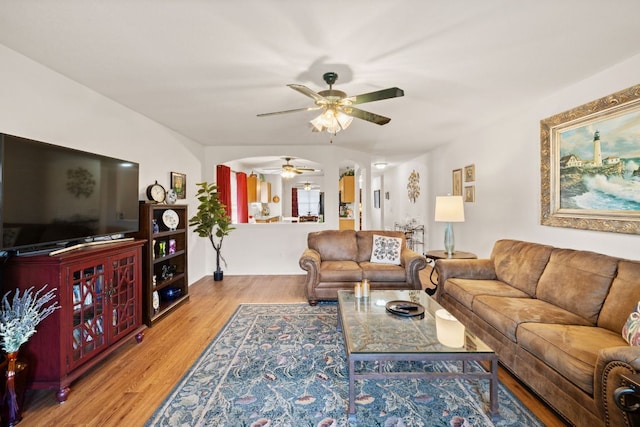 3919 Haleys Way, Round Rock, TX 78665 - living area featuring a ceiling fan, arched walkways, and wood finished floors