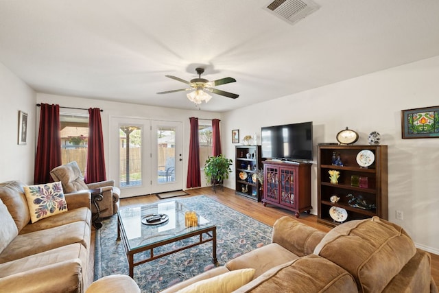 3919 Haleys Way, Round Rock, TX 78665 - living room with healthy amount of natural light, wood finished floors, a ceiling fan, and french doors