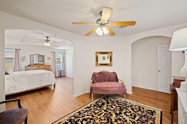 3919 Haleys Way, Round Rock, TX 78665 - bedroom with arched walkways, light wood-type flooring, baseboards, and a ceiling fan