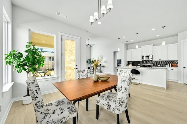 2316 Gold Dust Trl, Leander, TX 78641 - dining space with light wood-type flooring, recessed lighting, ceiling fan, and a chandelier