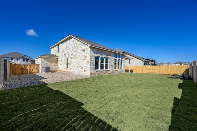 2316 Gold Dust Trl, Leander, TX 78641 - rear view of property featuring a fenced backyard and stone siding