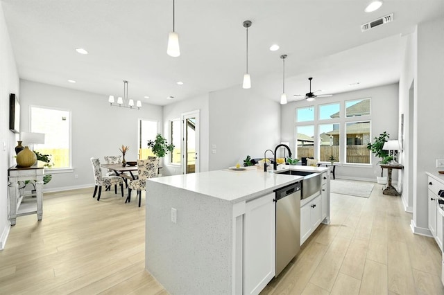 2316 Gold Dust Trl, Leander, TX 78641 - kitchen with dishwasher, a ceiling fan, recessed lighting, light wood-style floors, and hanging light fixtures