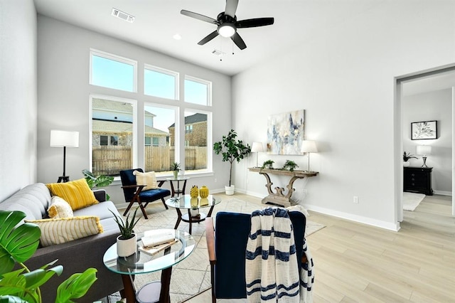 2316 Gold Dust Trl, Leander, TX 78641 - living area with light wood finished floors, a ceiling fan, and a towering ceiling