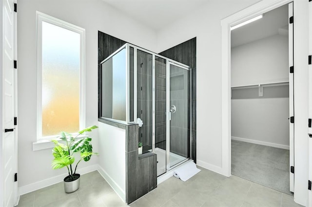 2316 Gold Dust Trl, Leander, TX 78641 - full bathroom with a shower stall, a spacious closet, and tile patterned floors