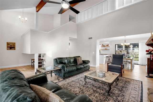 207 Lasso St, Horseshoe Bay, TX 78657 - living area featuring a chandelier, ceiling fan, high vaulted ceiling, and light wood-type flooring