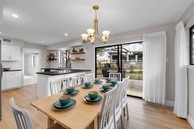 207 Lasso St, Horseshoe Bay, TX 78657 - dining space featuring a chandelier, light wood finished floors, and recessed lighting