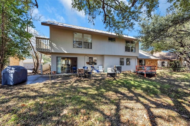 207 Lasso St, Horseshoe Bay, TX 78657 - rear view of property with a lawn, a metal roof, a deck, and a patio