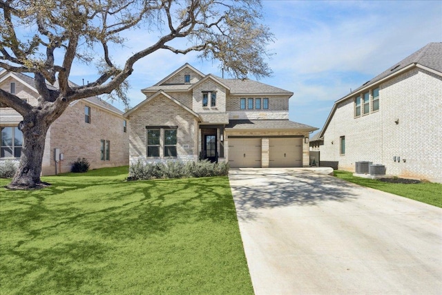 view of front of property featuring central air condition unit, an attached garage, driveway, brick siding, and a front yard