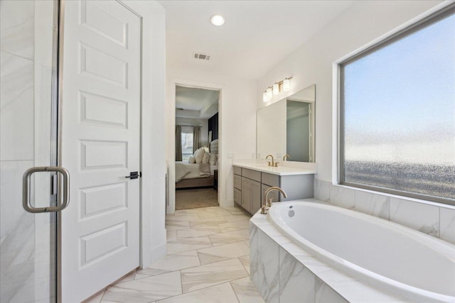 ensuite bathroom with marble finish floor, vanity, a bath, a stall shower, and ensuite bathroom