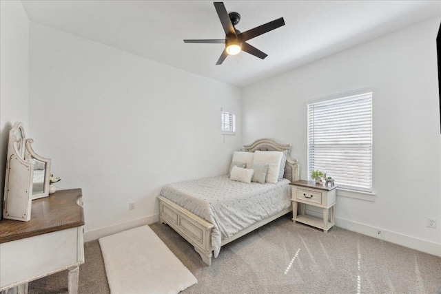 carpeted bedroom featuring a ceiling fan and baseboards