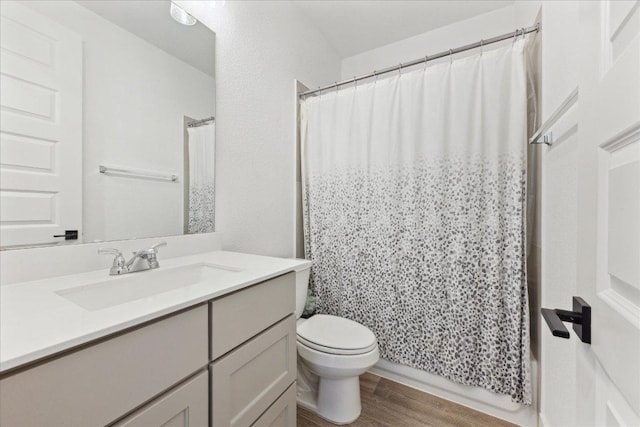 full bathroom with shower / bath combination with curtain, toilet, vanity, and wood finished floors