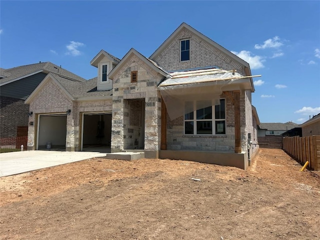8213 Grenadier Dr, Austin, TX 78738 - view of front of home featuring stone siding, concrete driveway, an attached garage, and brick siding