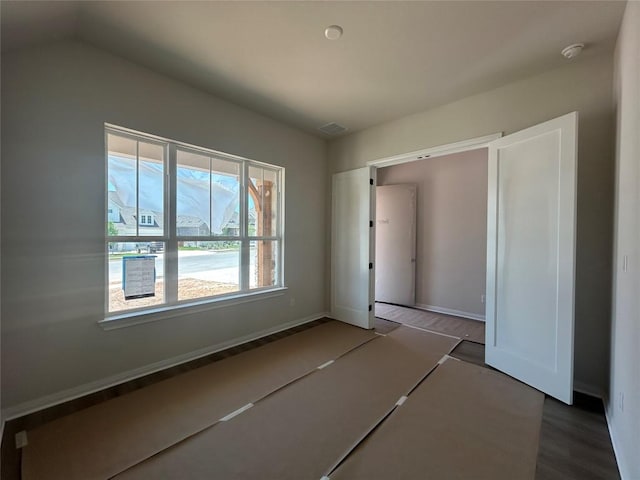 8213 Grenadier Dr, Austin, TX 78738 - unfurnished bedroom featuring wood finished floors and baseboards