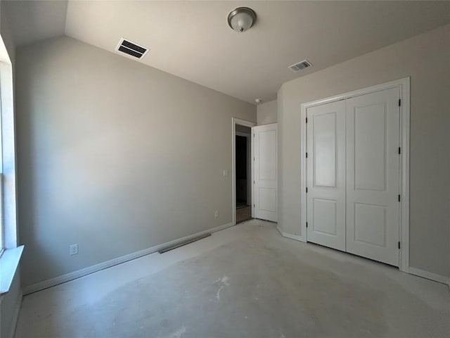 8213 Grenadier Dr, Austin, TX 78738 - unfurnished bedroom featuring a closet, concrete floors, baseboards, and vaulted ceiling