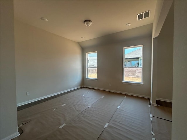 8213 Grenadier Dr, Austin, TX 78738 - empty room featuring baseboards and lofted ceiling