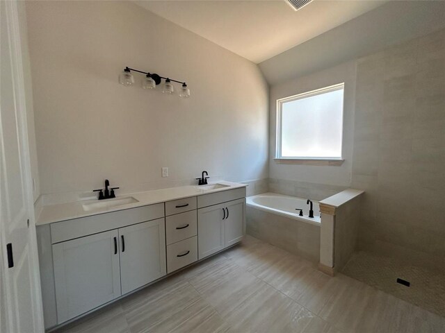 8213 Grenadier Dr, Austin, TX 78738 - full bath with a garden tub, double vanity, vaulted ceiling, and tiled shower