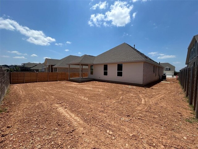 8213 Grenadier Dr, Austin, TX 78738 - rear view of house featuring a fenced backyard, a patio area, and brick siding