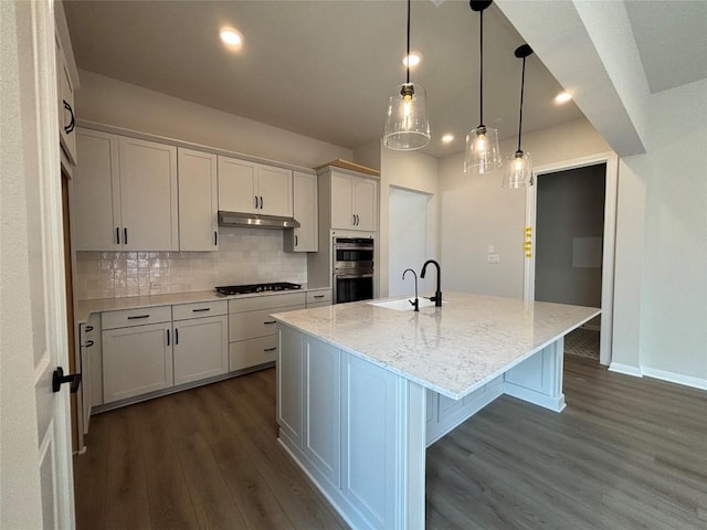 8213 Grenadier Dr, Austin, TX 78738 - kitchen featuring stainless steel double oven, gas cooktop, dark wood-style flooring, decorative backsplash, and light stone countertops