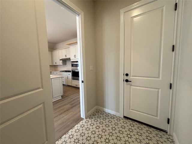 8213 Grenadier Dr, Austin, TX 78738 - doorway with baseboards and light floors