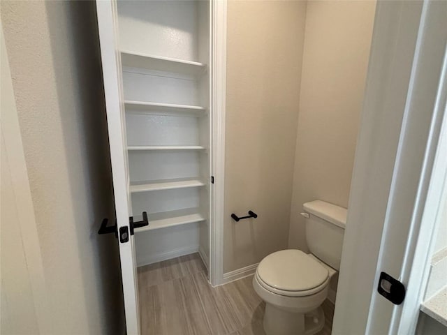 8213 Grenadier Dr, Austin, TX 78738 - bathroom featuring wood finished floors and toilet