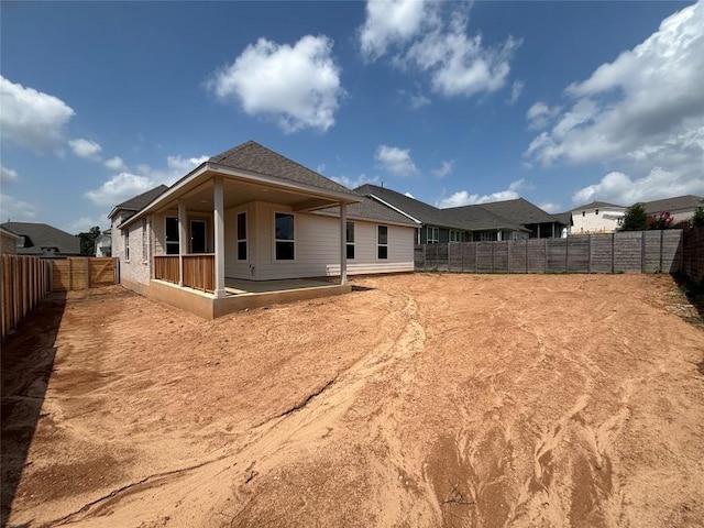 8213 Grenadier Dr, Austin, TX 78738 - back of house featuring a fenced backyard and roof with shingles
